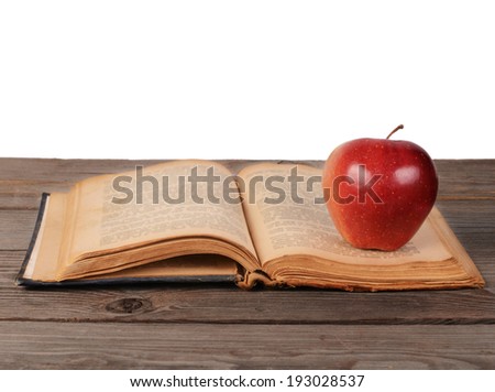 Open book with apple isolated on white