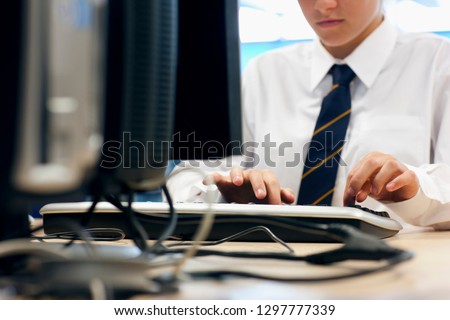 Female high school student in uniform in computer science lesson