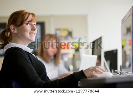 Smiling female high school student in computer science lesson