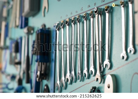 Row of new spanners on display rack in shop, close-up (differential focus)
