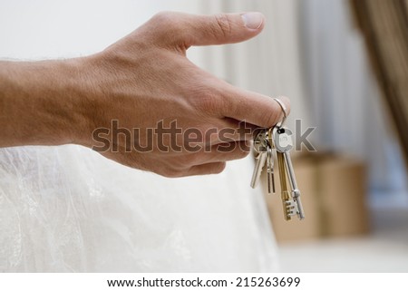 Man holding set of keys, close-up of hand, side view