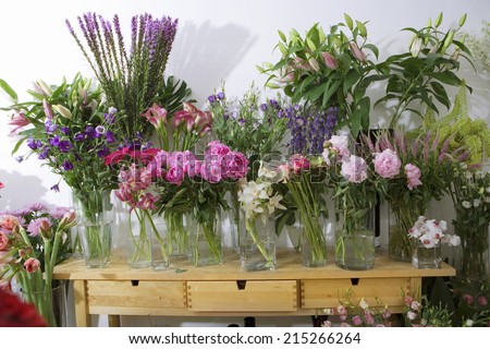 Variety of flowers in vases on display in flower shop