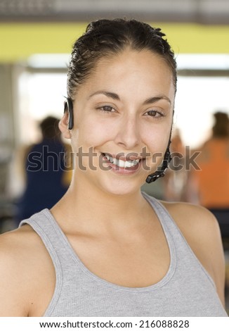 Woman wearing headset, smiling, portrait