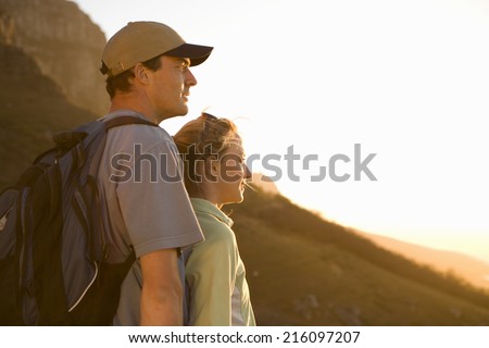 Young hikers looking at view, side view