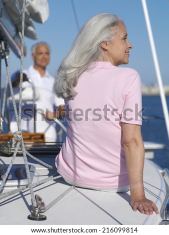 Senior couple on sailing boat, rear view of woman