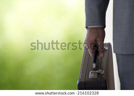Close up of businessman holding briefcase