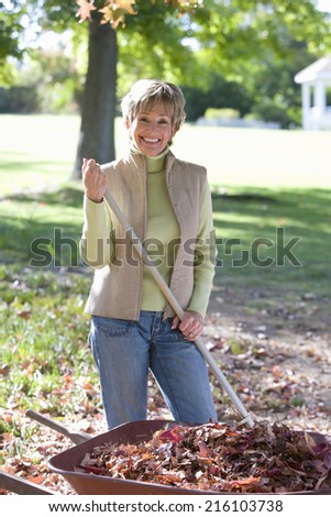 Senior woman doing yard work in autumn
