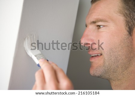 Man painting wall, close-up