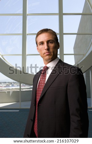 Businessman standing in front of round window