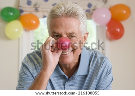 Man blowing up birthday balloons