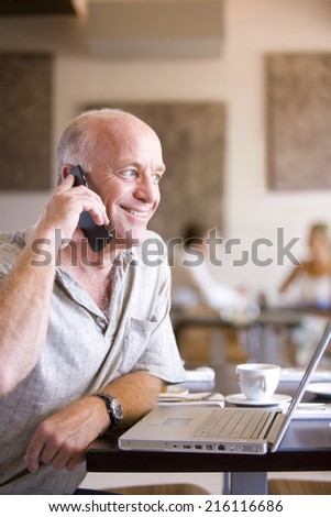 Man talking on cell phone in cafe