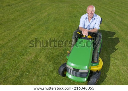 Portrait of man on riding lawn mower