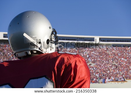 Football player looking at crowd in stadium