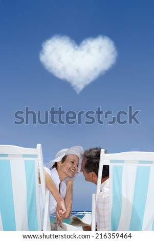Couple in lounge chairs with heart cloud overhead