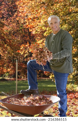 Man doing yard work in autumn