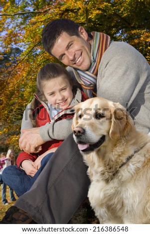 Father, daughter and dog outdoors