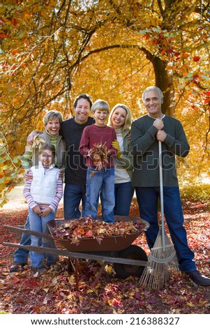 Three generation family doing yard work in autumn