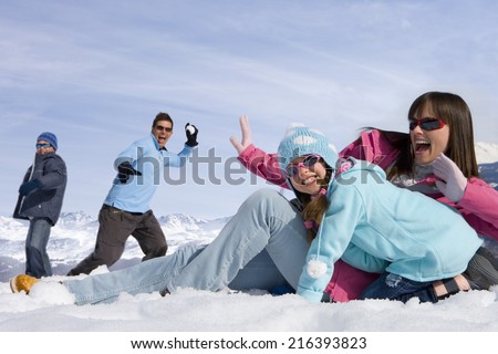 Family having snowball fight in the snow