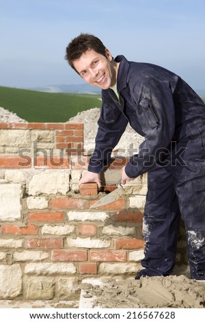 Man bricklaying wall with trowel