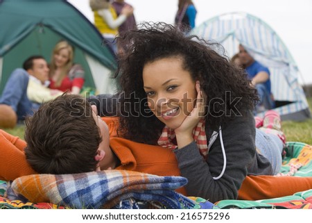 Romantic couple camping and attending outdoor festival