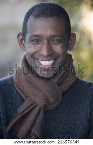 Happy man smiling and wearing scarf