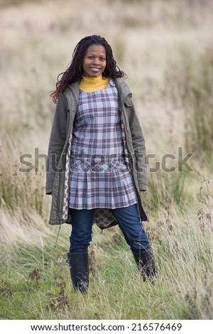 smiling woman standing in field