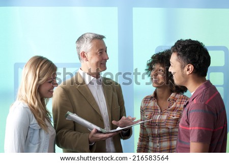 Smiling teacher talking with students