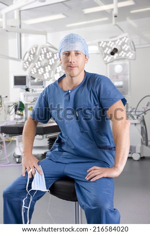 Surgeon sitting on stool in hospital operating room