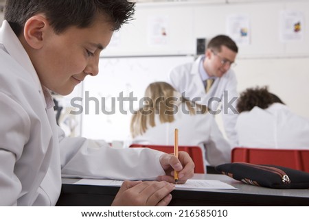 School boy taking test in school chemistry lab