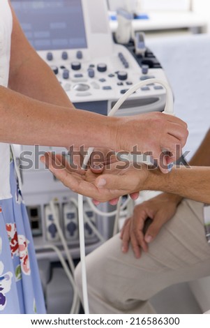 Technician using ultrasound treatment on patientÃ¢Â?Â?s wrist