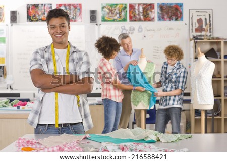 Smiling student sewing clothing in home economics classroom