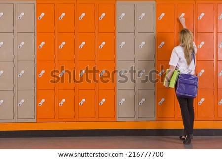 Student unlocking school locker