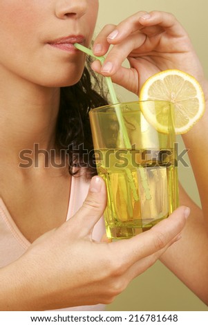 A woman drinking with a straw.