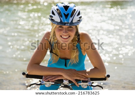 A woman wearing a cycling helmet.