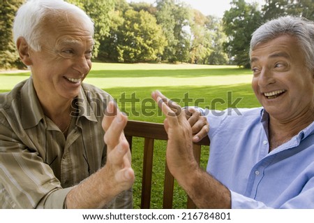 Two elderly men having a laugh.