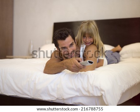 Daughter lying on fathers back.
