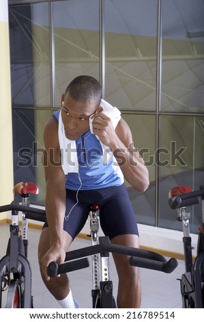 Man listening to music in the gym.