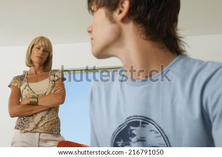 Boy upset, mother in the background.
