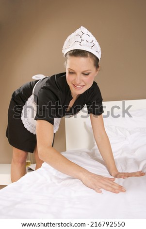 Close-up of a maid cleaning a bed sheet