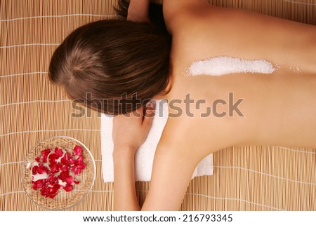 A woman with salt on her back for a massage.