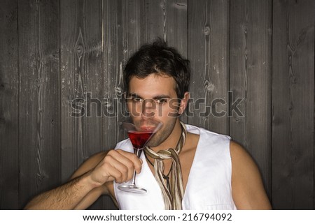 Portrait of a young man having a drink