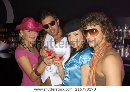 Four friends having drinks at a club