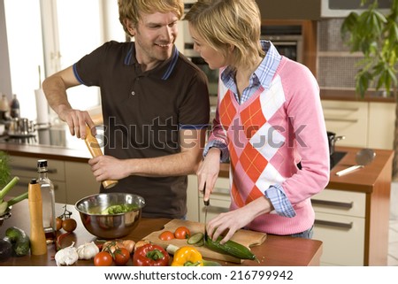 Couple making salad.