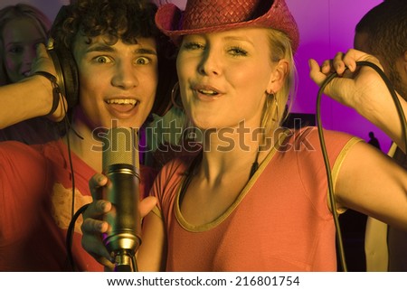 Close-up of a young couple singing in a nightclub