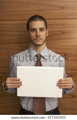 Portrait of a businessman holding a laptop