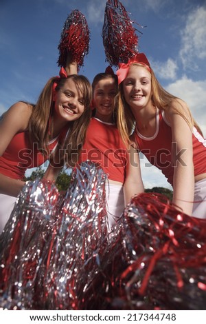 Portrait of three cheerleaders cheering