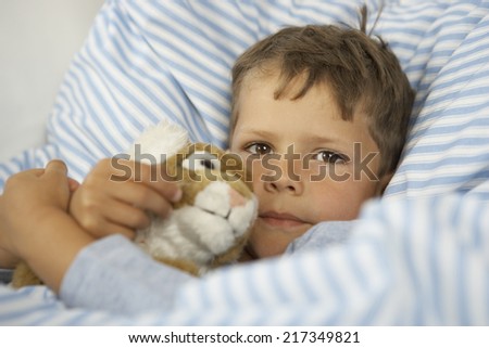 Portrait of a boy playing with a stuffed toy