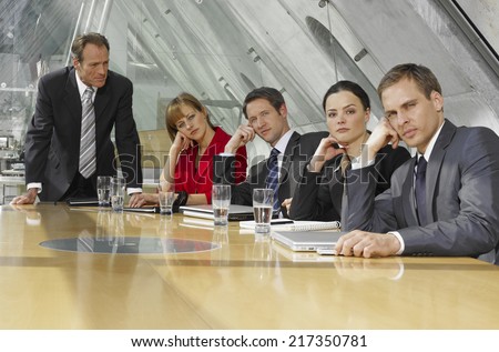 Five business executives in a board room