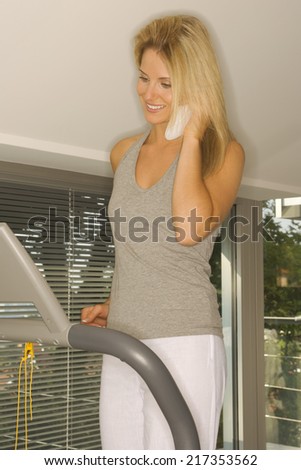 Woman on treadmill phoning