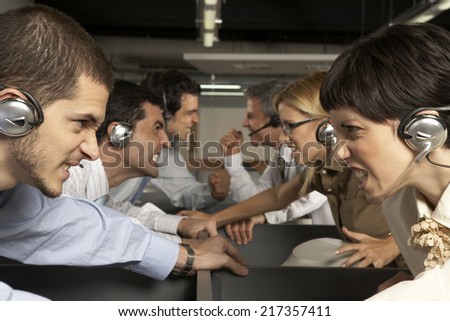 Group of customer service representatives looking at each other and clenching teeth